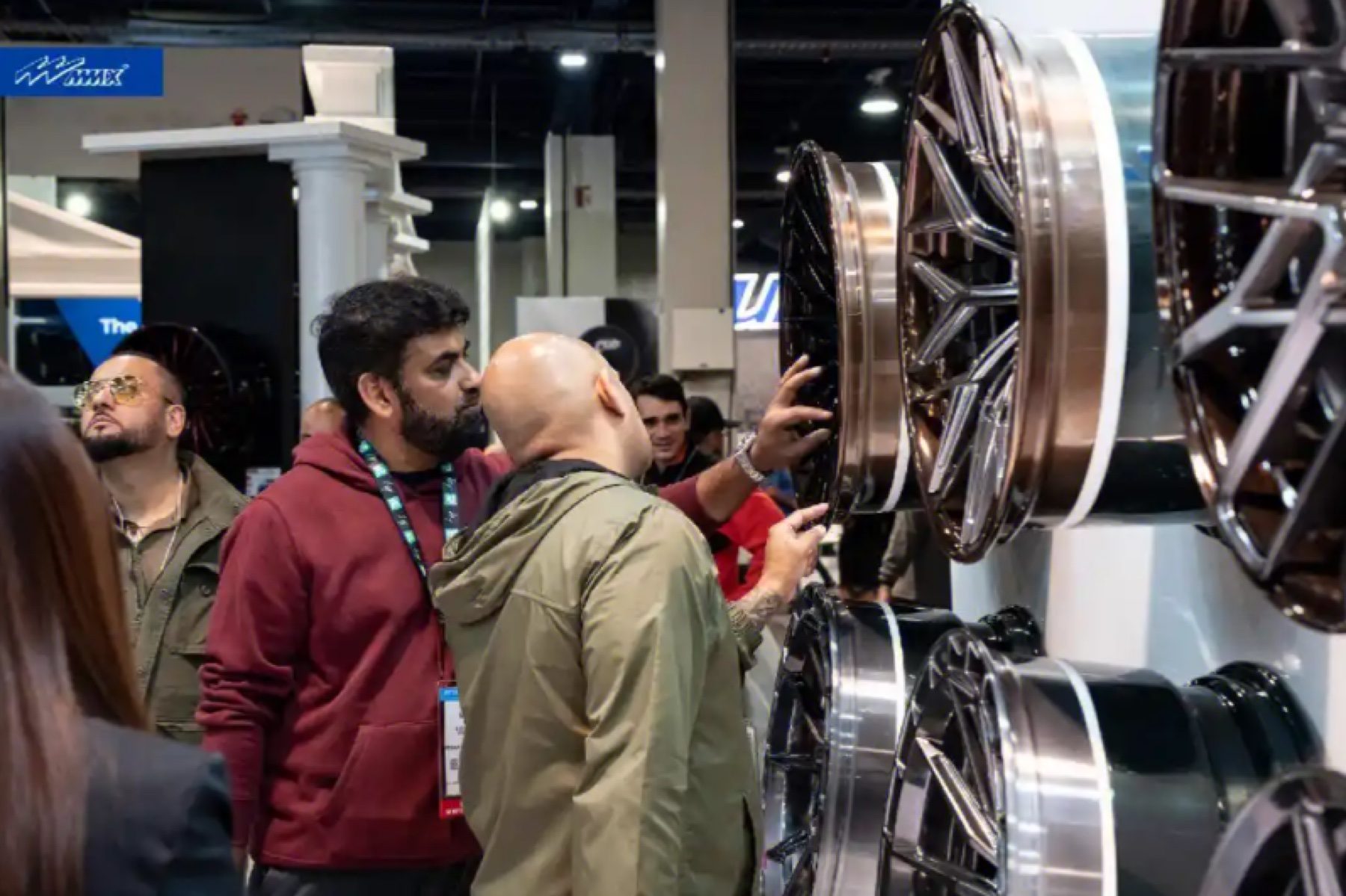 Buyers reviewing forged wheel faces on the show floor