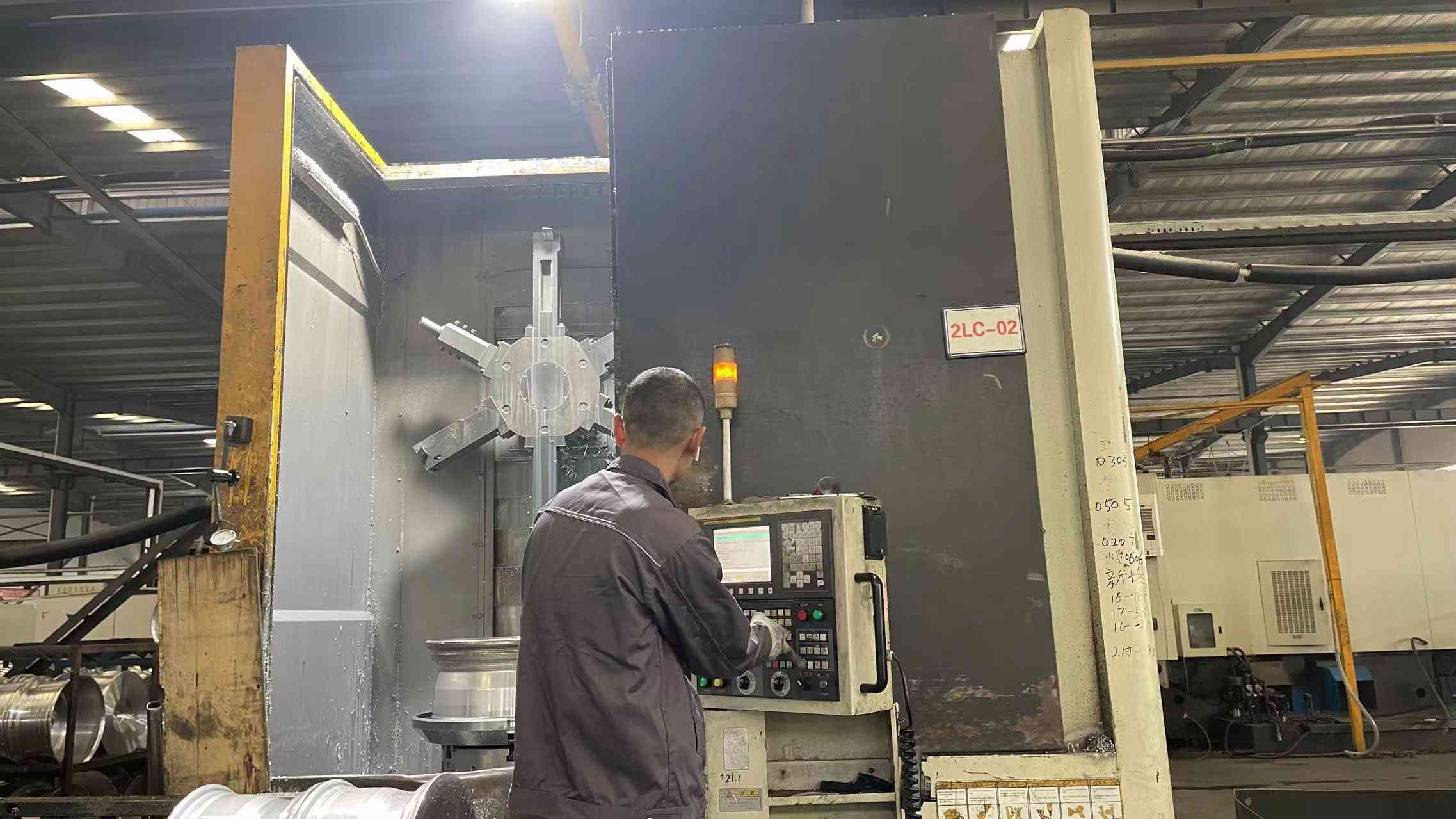 CNC vertical lathe turning a wheel blank